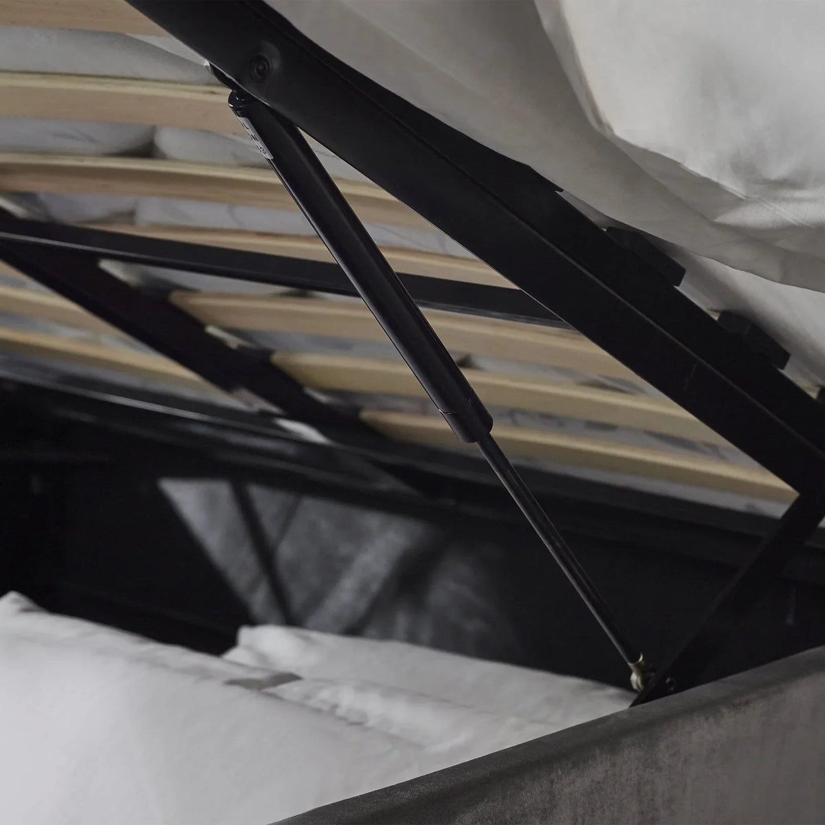 Lift-up storage bed gas lift mechanism and slatted base in close detail