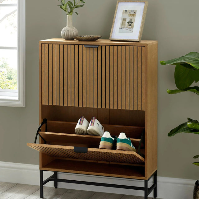 Wood shoe storage cabinet with slatted doors, pull-down compartment and two pairs of trainers