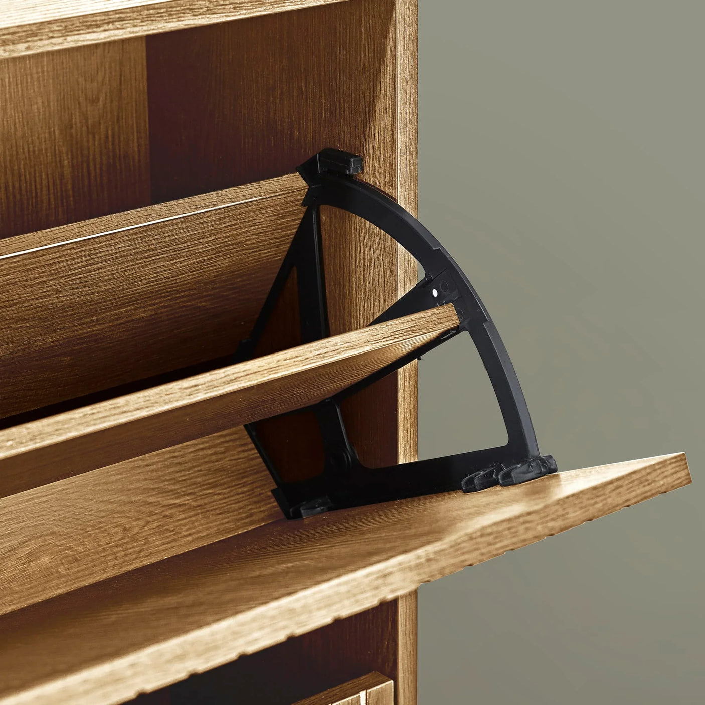 Close up of wood shoe cabinet with open tilting shelf and black support mechanism