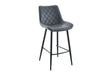A modern bar stool with a dark gray quilted faux-leather seat and backrest, supported by slim black metal legs and a footrest, shown against a plain white background.