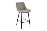 A modern bar stool with a light taupe-gray quilted velvet upholstered seat and backrest, supported by slim black metal legs.