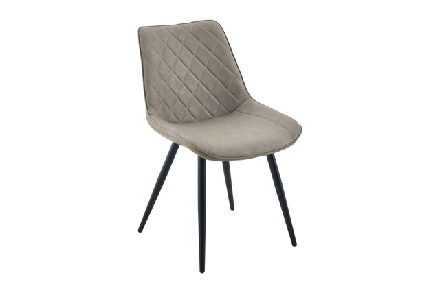 A modern dining chair with a light taupe-gray quilted velvet upholstered seat and backrest, supported by four slim black metal legs, shown against a plain white background.