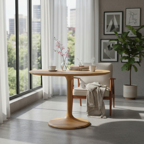 Wooden dining table with chairs in a bright room with large windows.