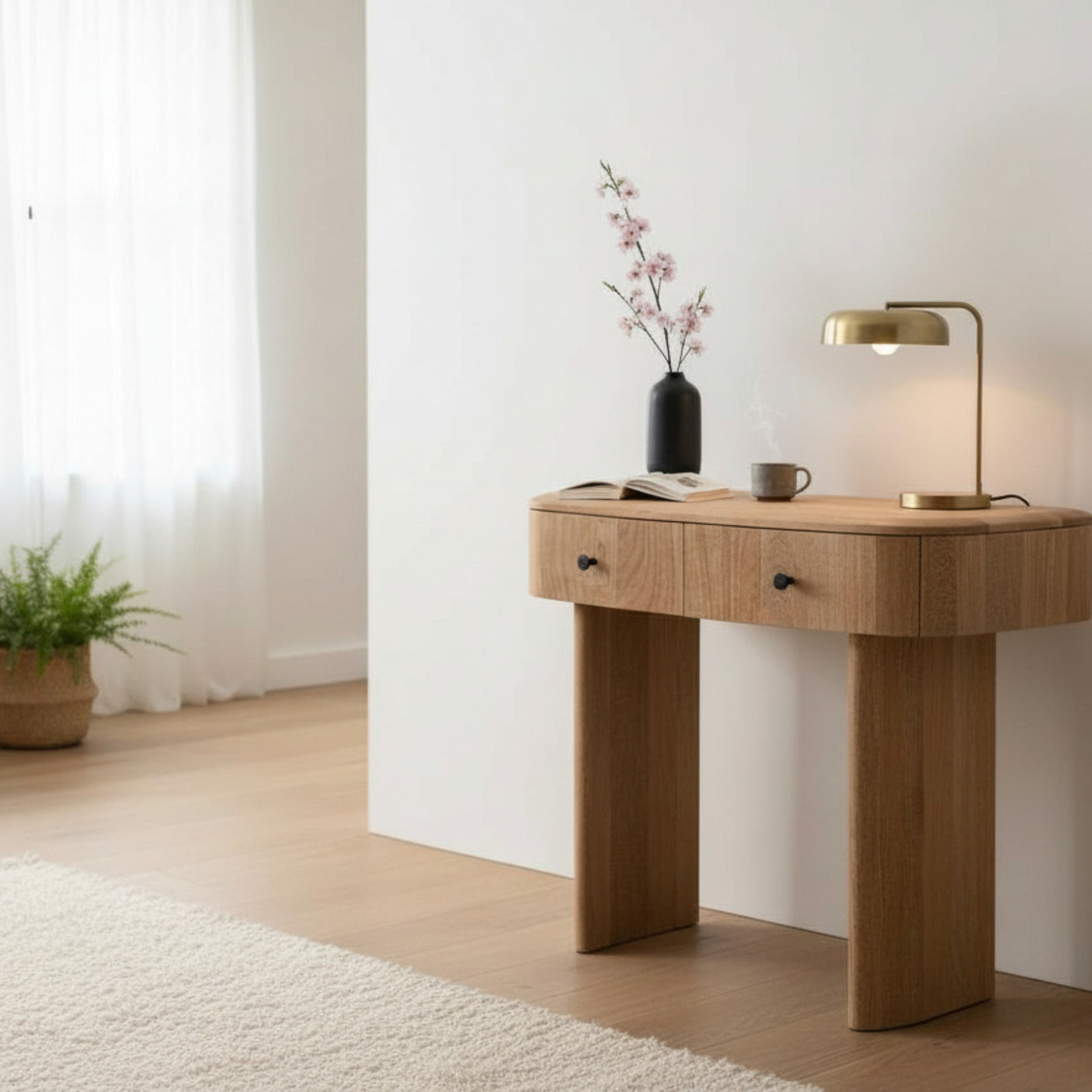 Wooden desk with a lamp, mug, and vase in a minimalistic room.
