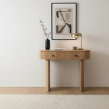 Wooden console table with decorative items against a white wall