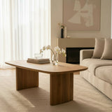 Modern living room with a wooden coffee table, beige sofa, and abstract art on the wall.
