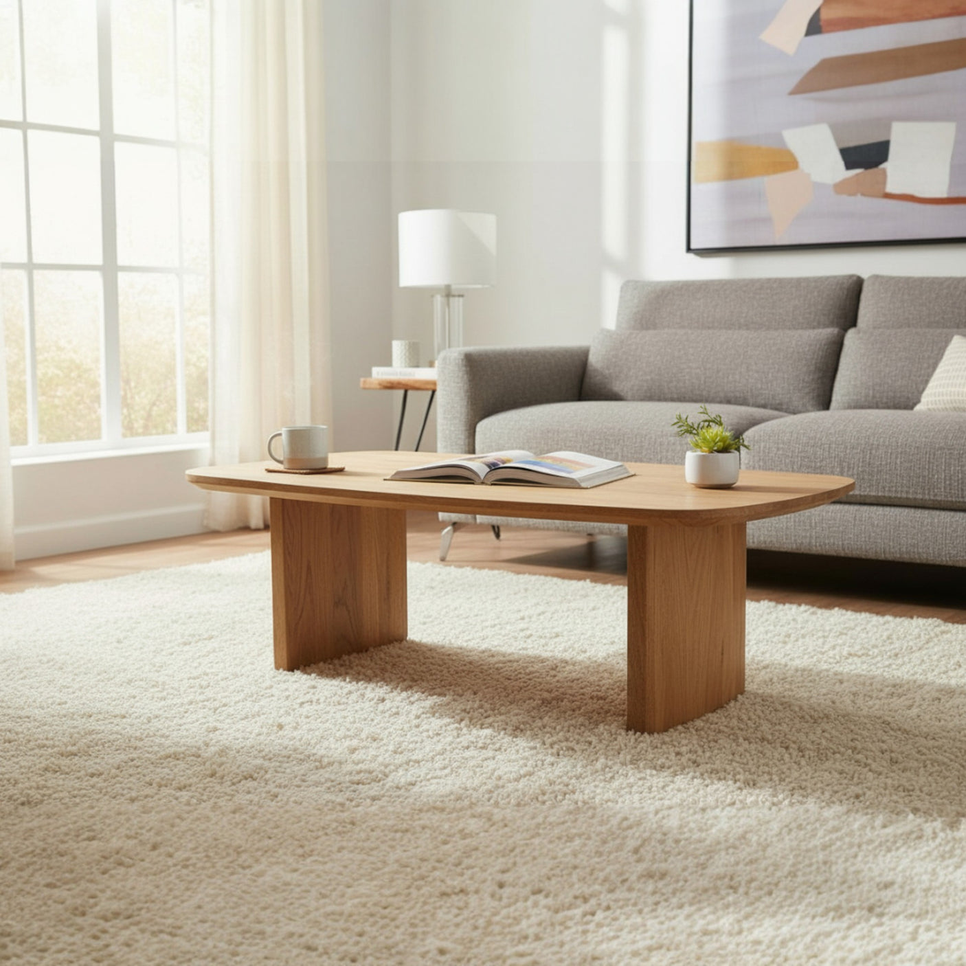 Living room with a wooden coffee table, gray sofa, and abstract painting on the wall.