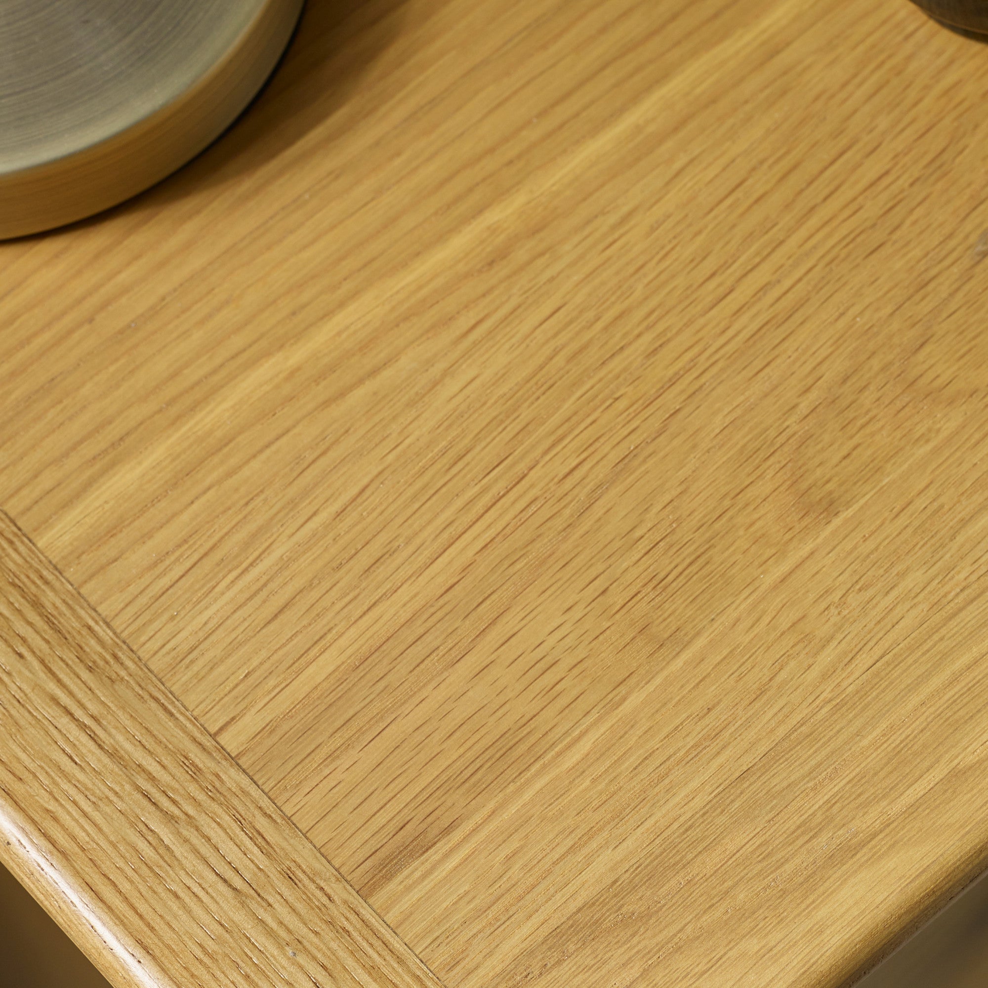 Close-up of wood grain detail on surface of light oak bedside table top