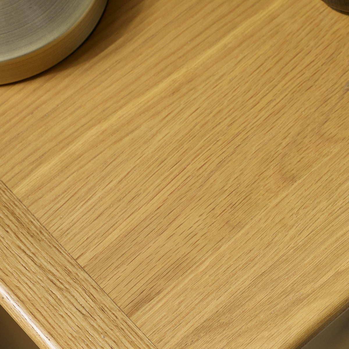 Close-up of wood grain detail on surface of light oak bedside table top