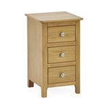 Light oak 3 drawer bedside table photographed from a slight front angle on white background