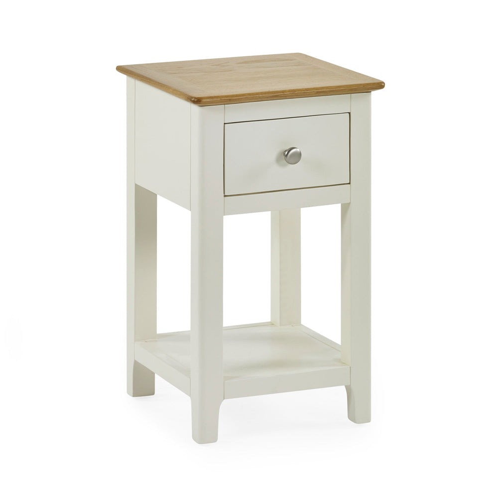 Cream painted bedside table with oak top on white background, drawer closed, angled front view