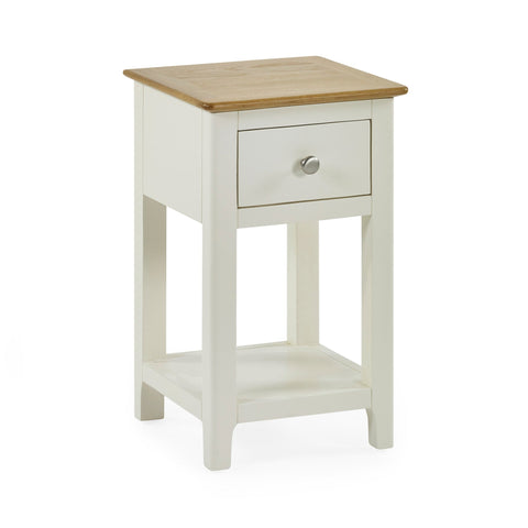 Cream painted bedside table with oak top on white background, drawer closed, angled front view