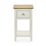 Front view of cream painted bedside table with oak top and closed drawer on white background