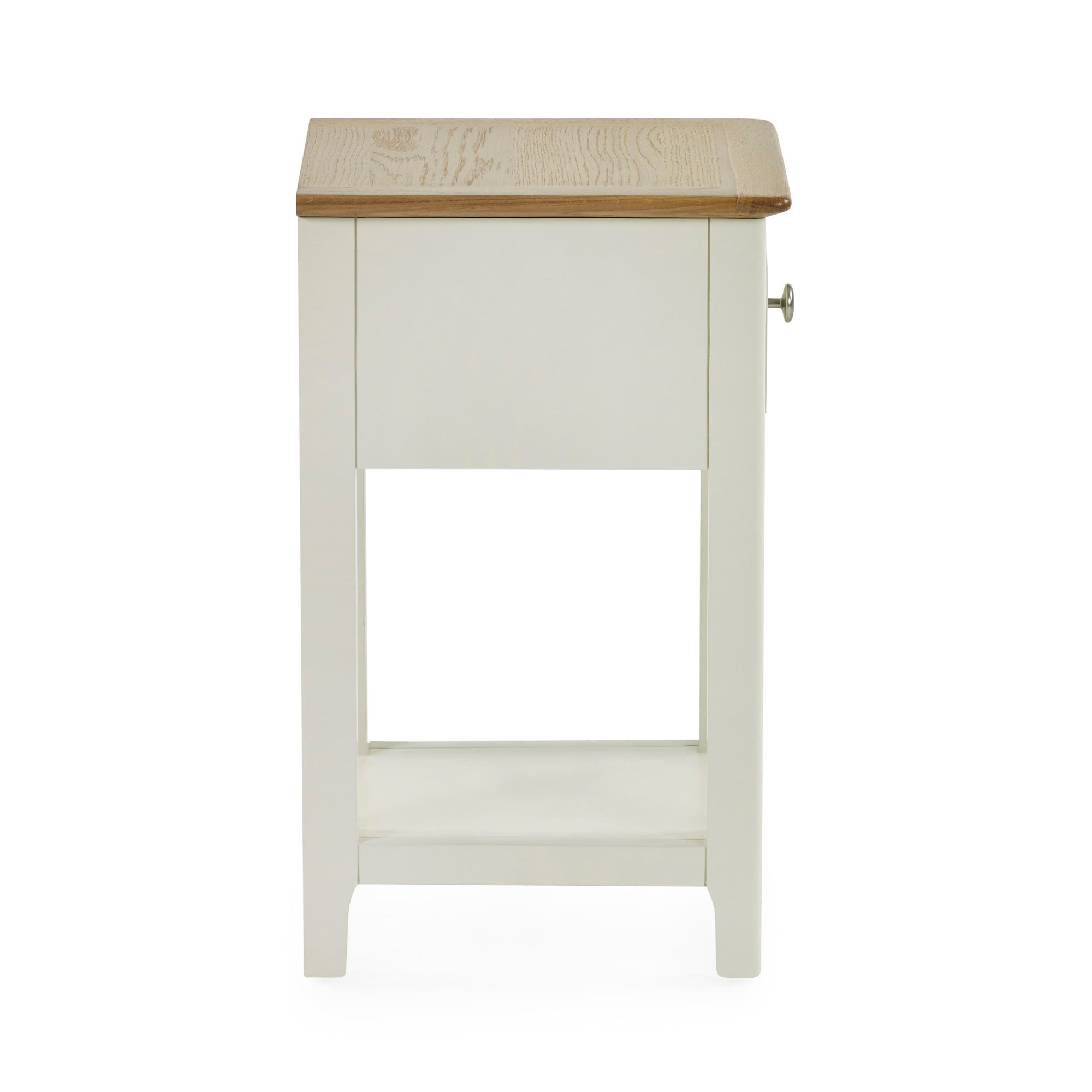 Side view of cream painted bedside table with oak top and closed drawer on white background
