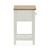 Side view of cream painted bedside table with oak top and closed drawer on white background