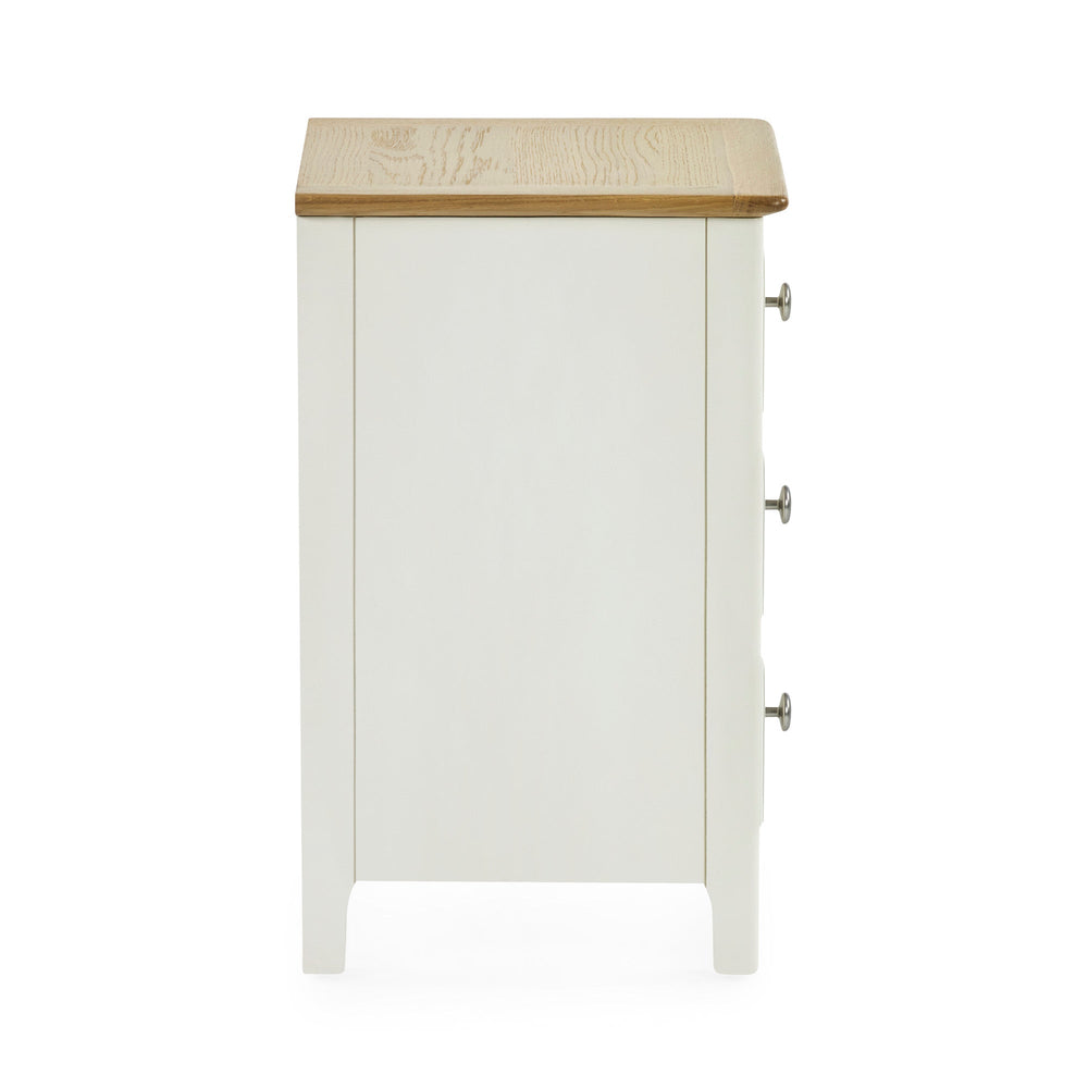 Cream colored 3 drawer bedside with oak top side view against white background