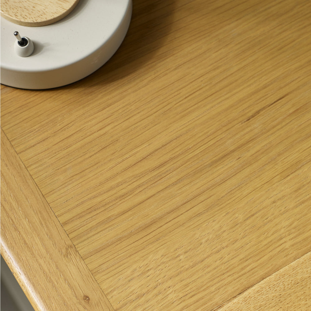 Close-up of natural wood grain on bedside table top, emphasizing fine vertical and diagonal wood lines