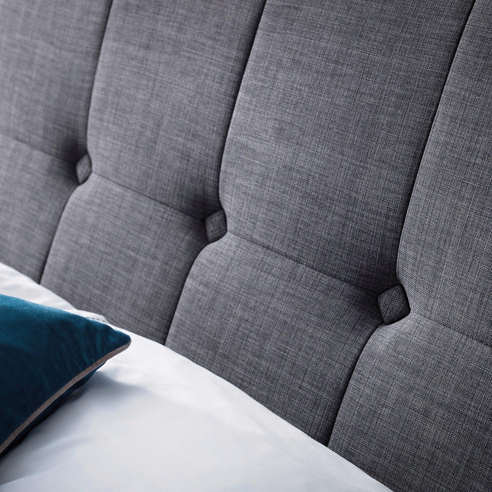 Close-up of Sorrento linen king bed headboard in slate with tufted fabric detail