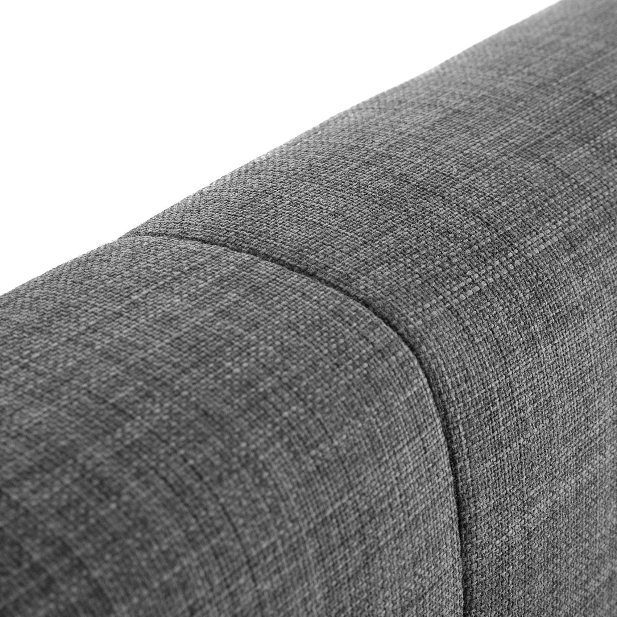Close detail of slate linen king bed headboard upholstery and stitching