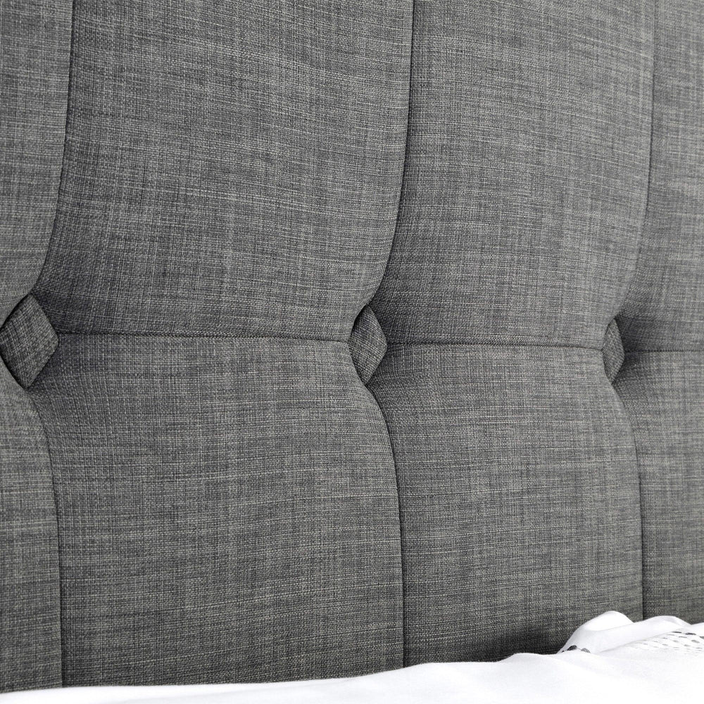 Close-up of slate linen bed headboard with stitched panel detail