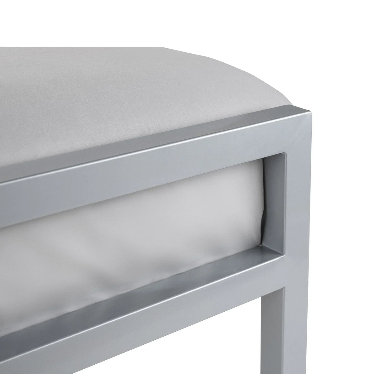 Silver metal bed frame close-up showing corner and mattress detail