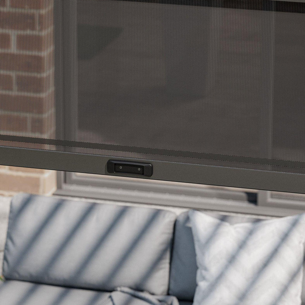 Outdoor sofa with grey cushions under a retractable mesh screen on patio