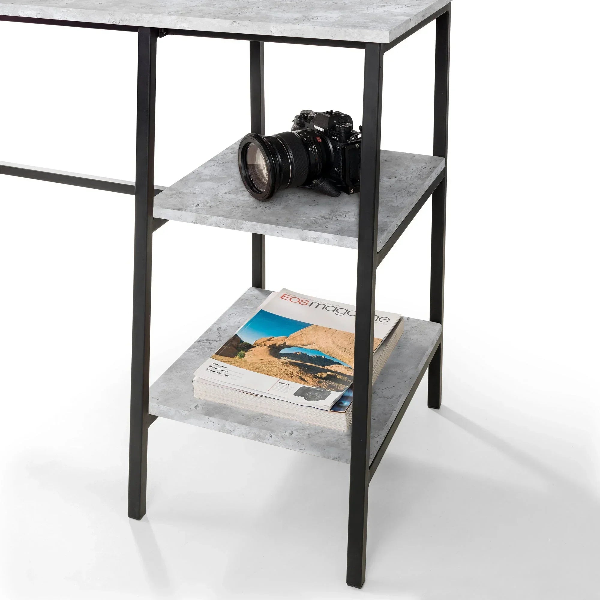 Concrete effect desk with two open shelves holding a camera and magazines