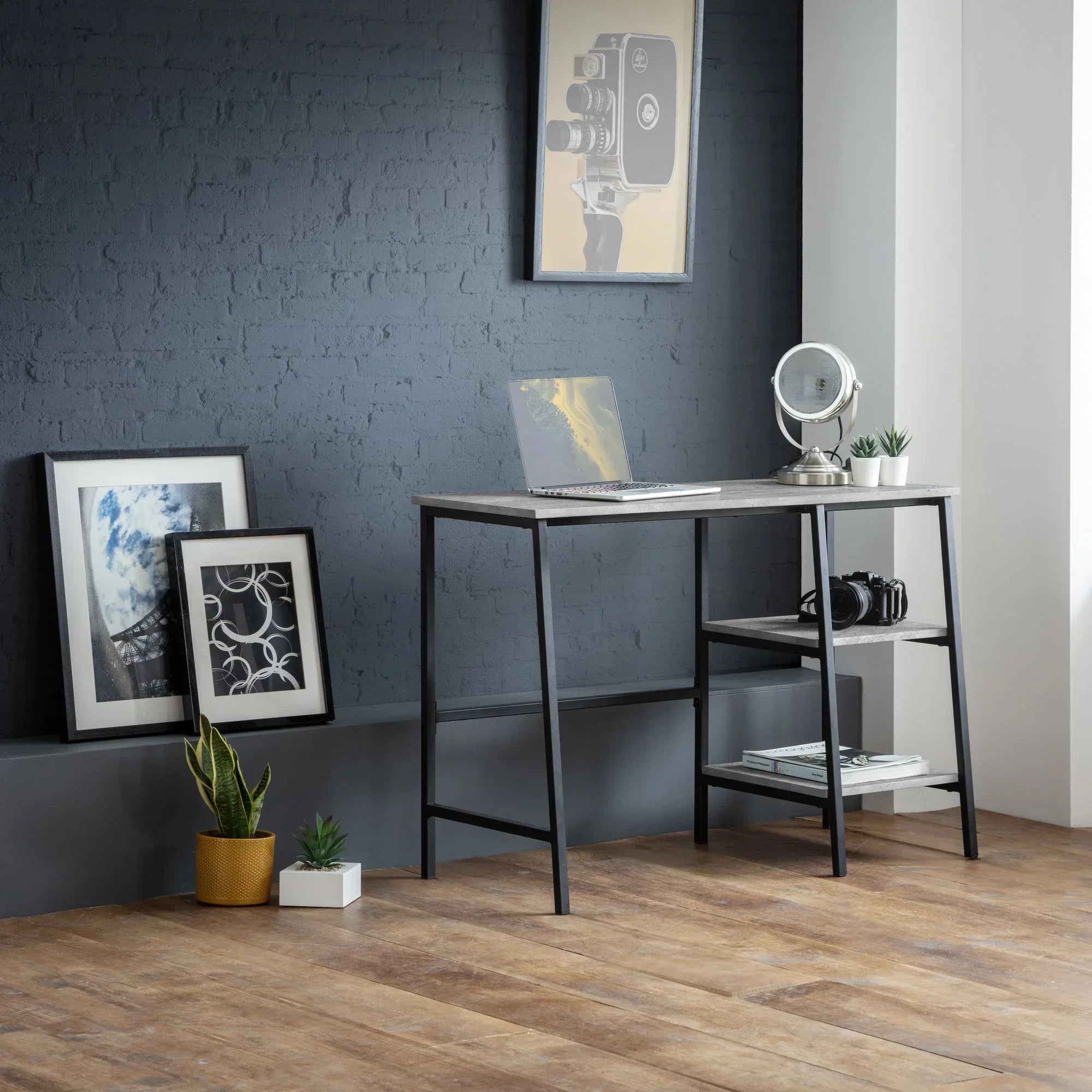 Modern wooden Staten desk with metal frame and shelves in a minimalist home office setting