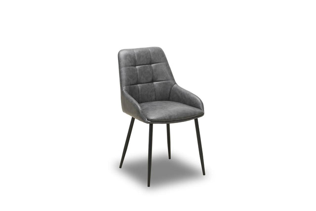 A modern gray upholstered dining chair with a tufted backrest and slim black metal legs, shown on a plain white background.