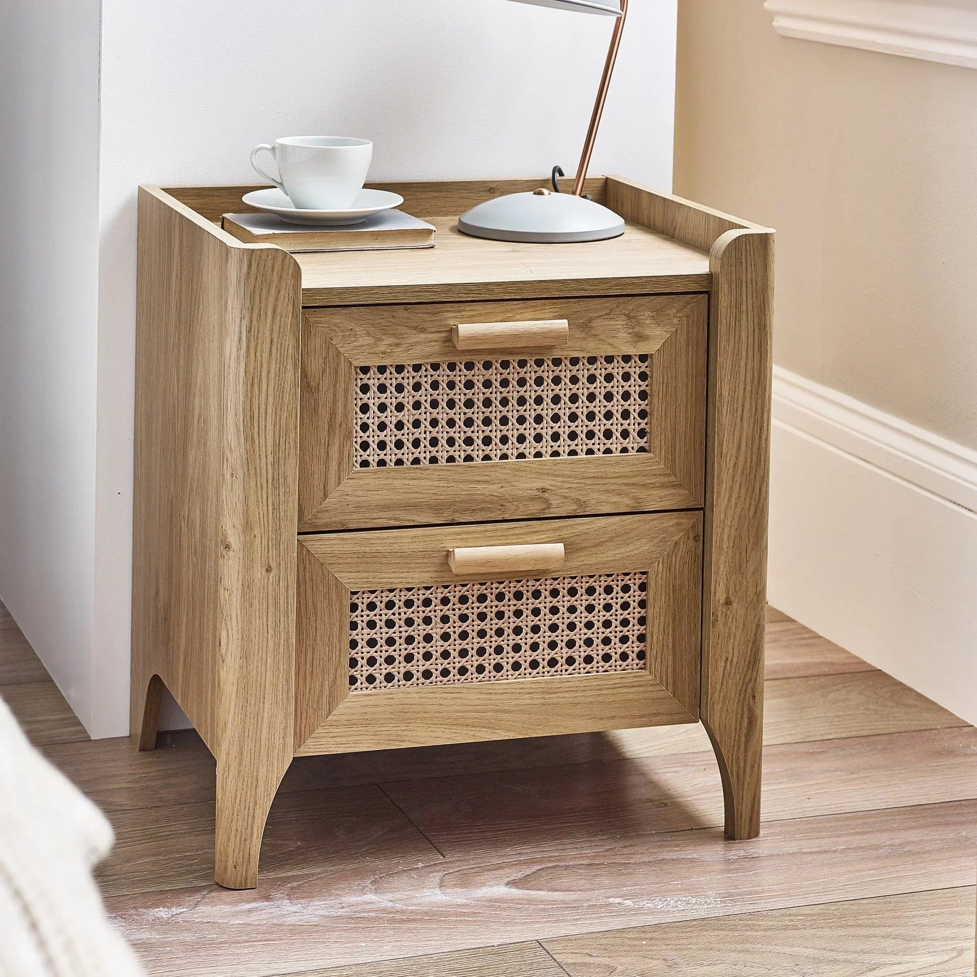 Rattan effect two drawer bedside table with wooden frame in modern bedroom setting