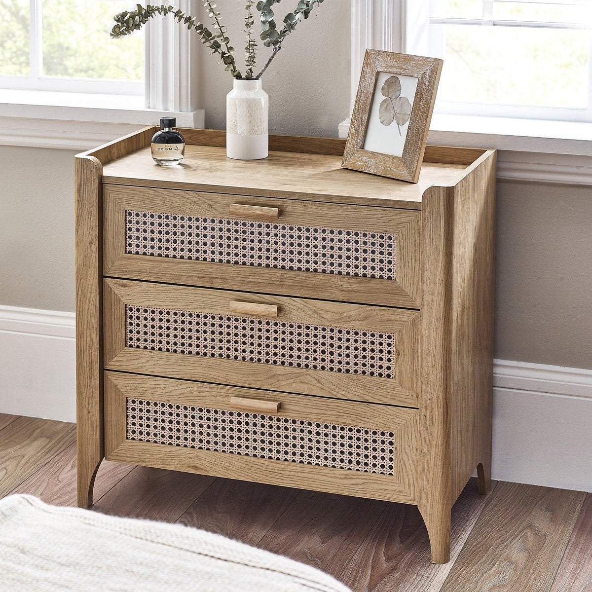 Sydney rattan effect 3 drawer chest with wooden frame in bright bedroom corner