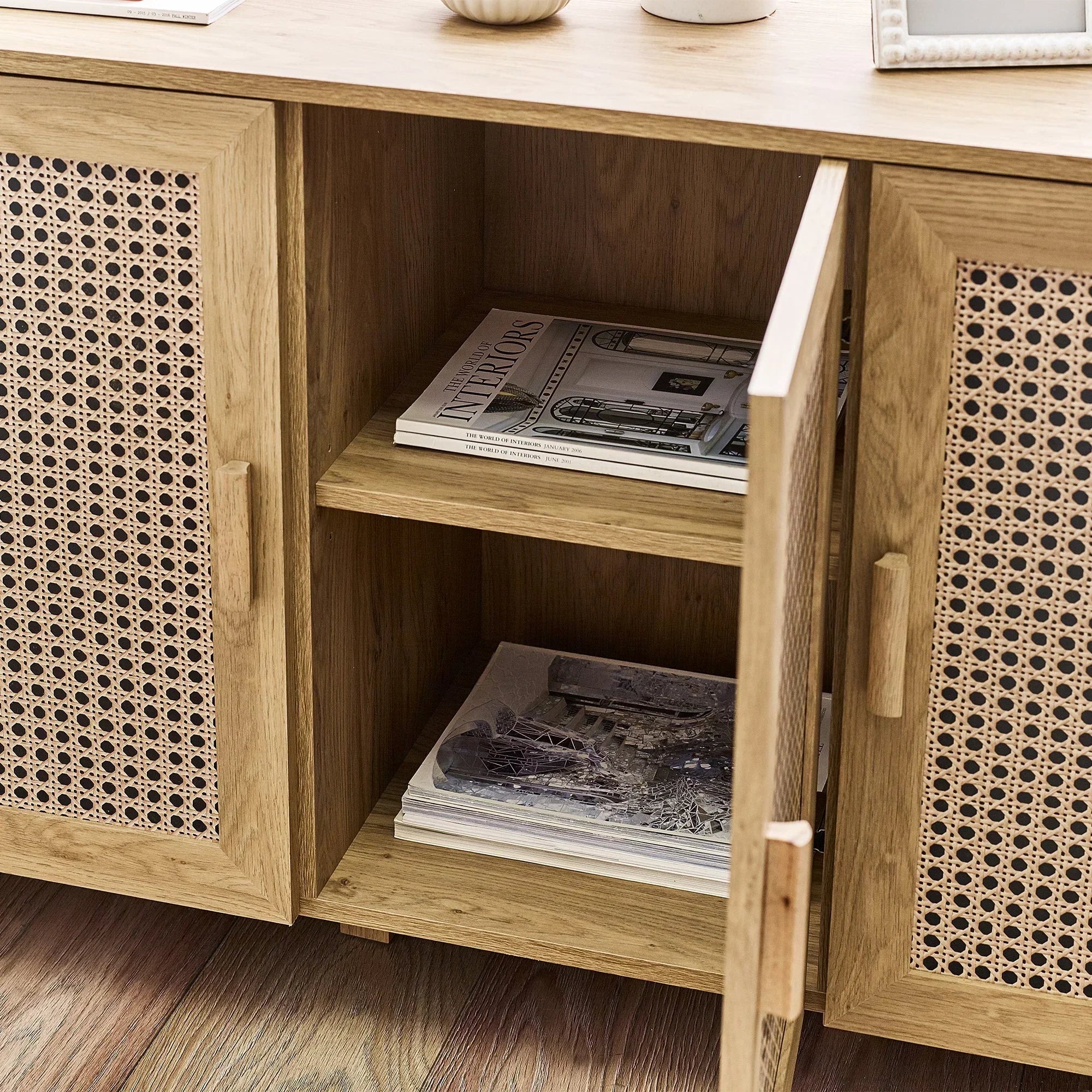 Sydney rattan effect sideboard open door showing shelves with magazines and wooden finish