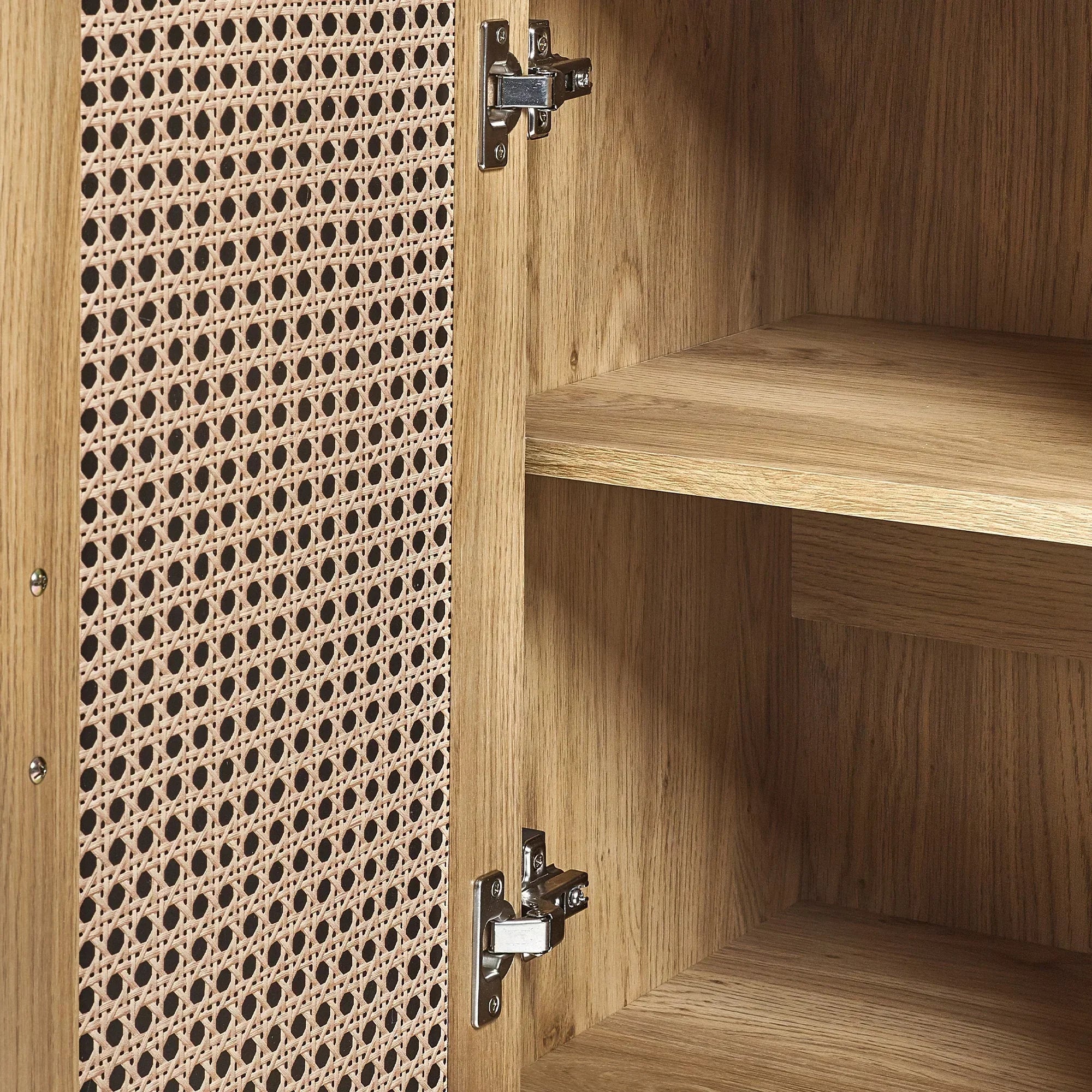 Rattan effect sideboard door open showing wood grain shelves and interior hinge detail