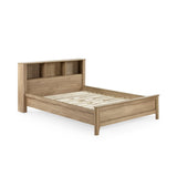 Empty oak wood bed frame with slatted base and built-in shelving in headboard, isolated on white background