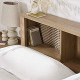 Close-up of oak headboard shelving with books, lamp and decorative vase on top