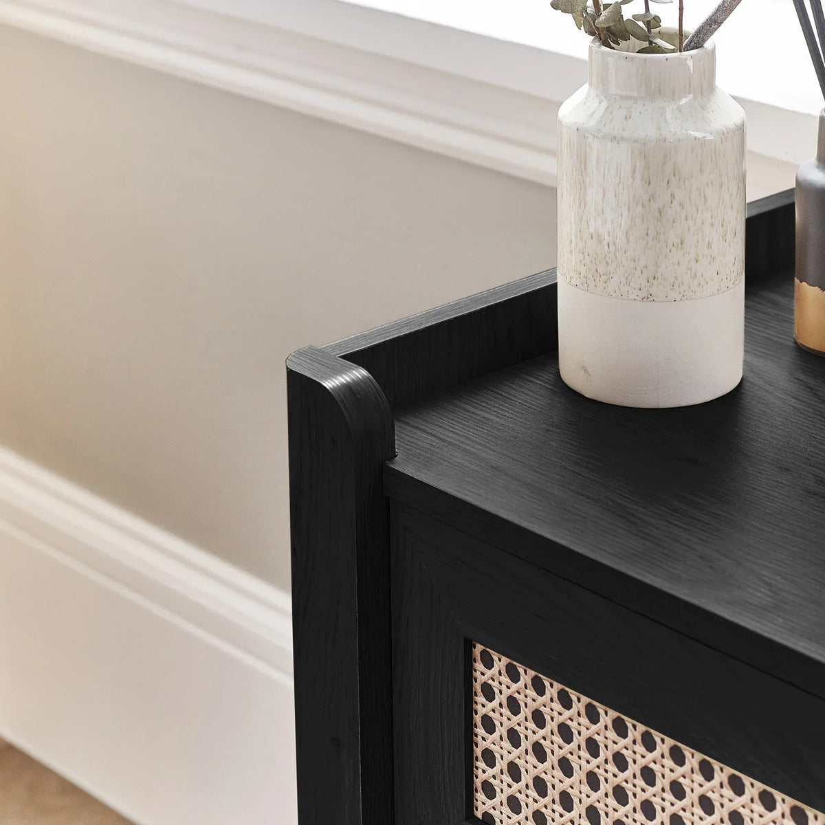 Detail of Sydney rattan effect black ash chest with decorative ceramic vase on top