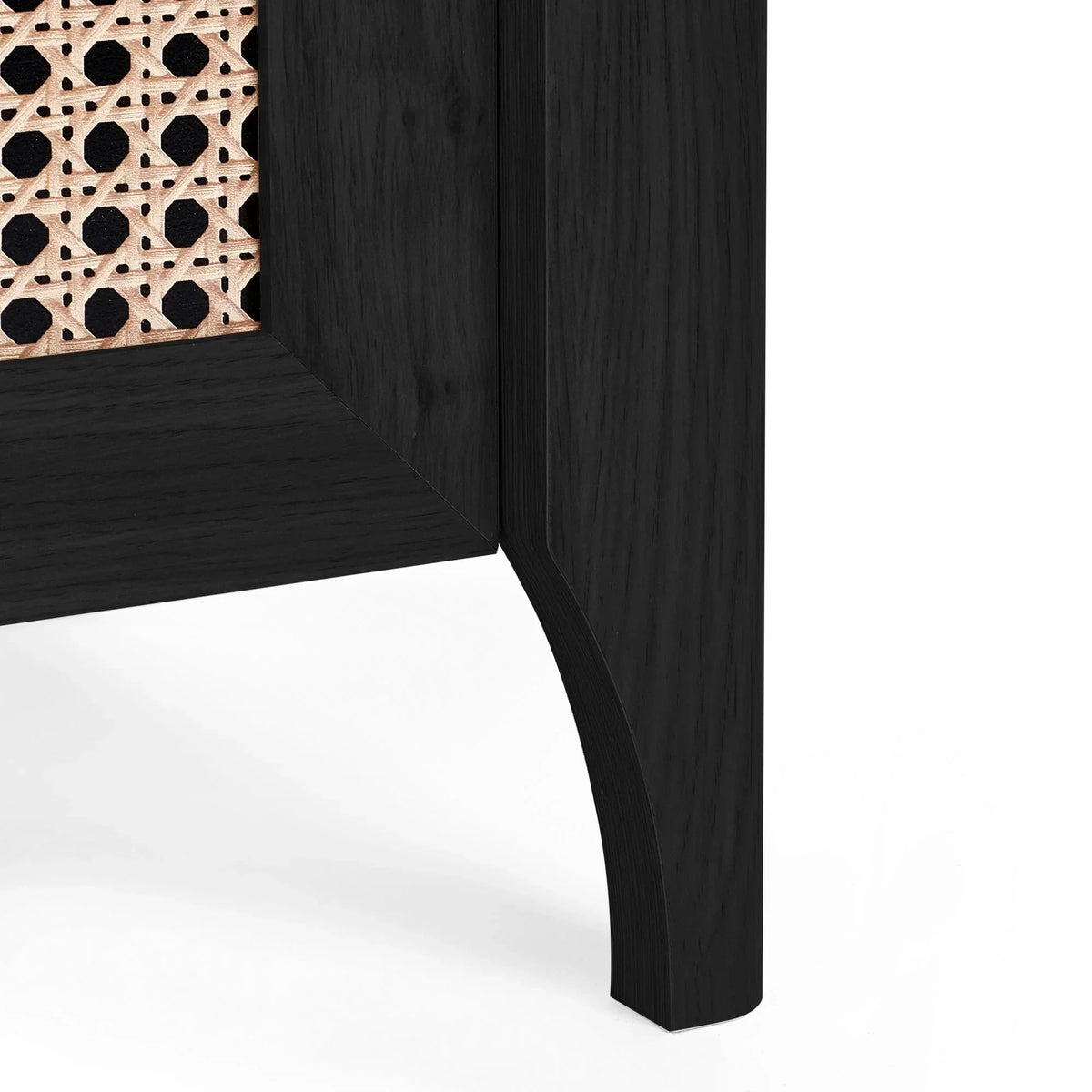 Corner detail of Sydney rattan effect black ash chest with cane panel and curved leg