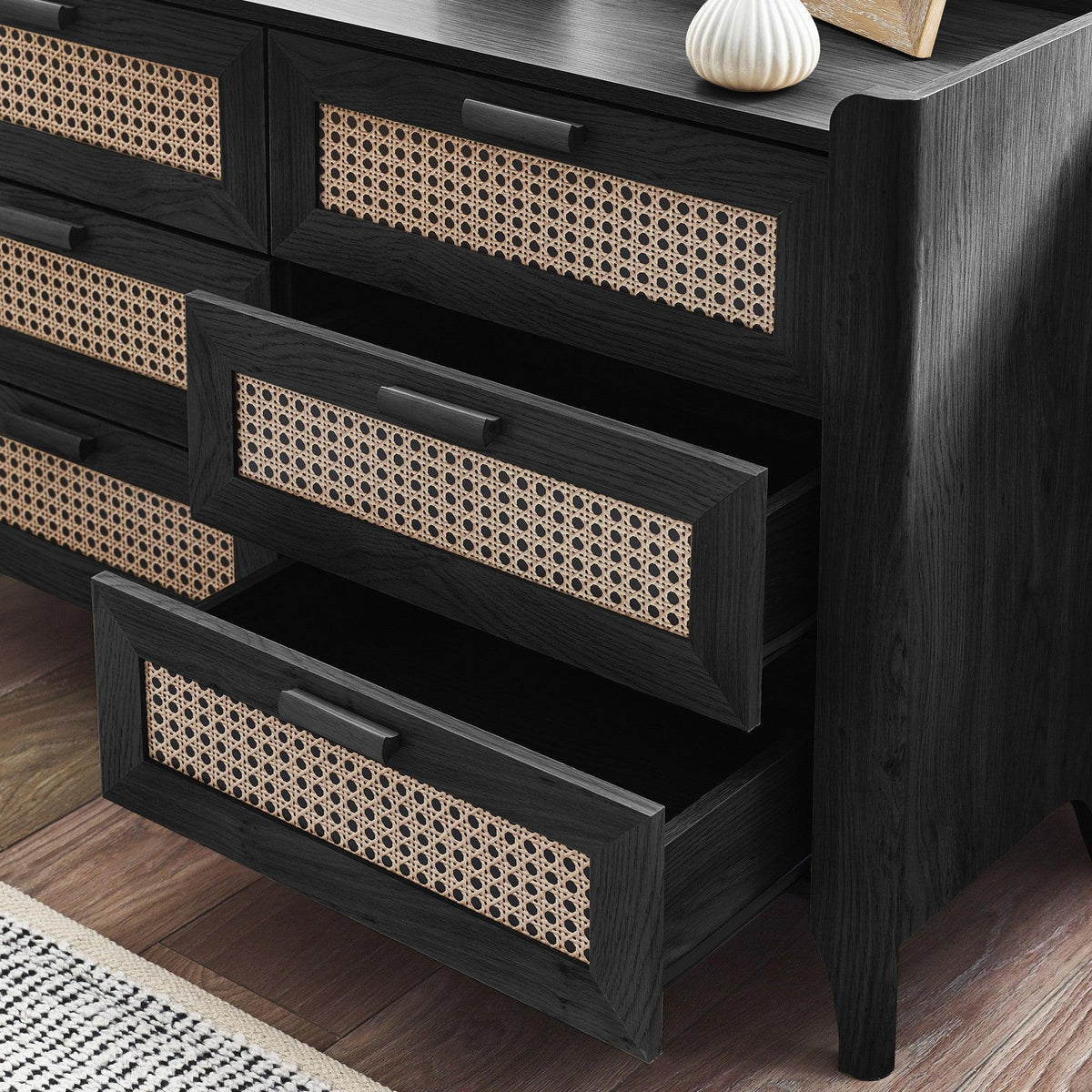 Black ash rattan effect chest of drawers with two open drawers, showing woven detail