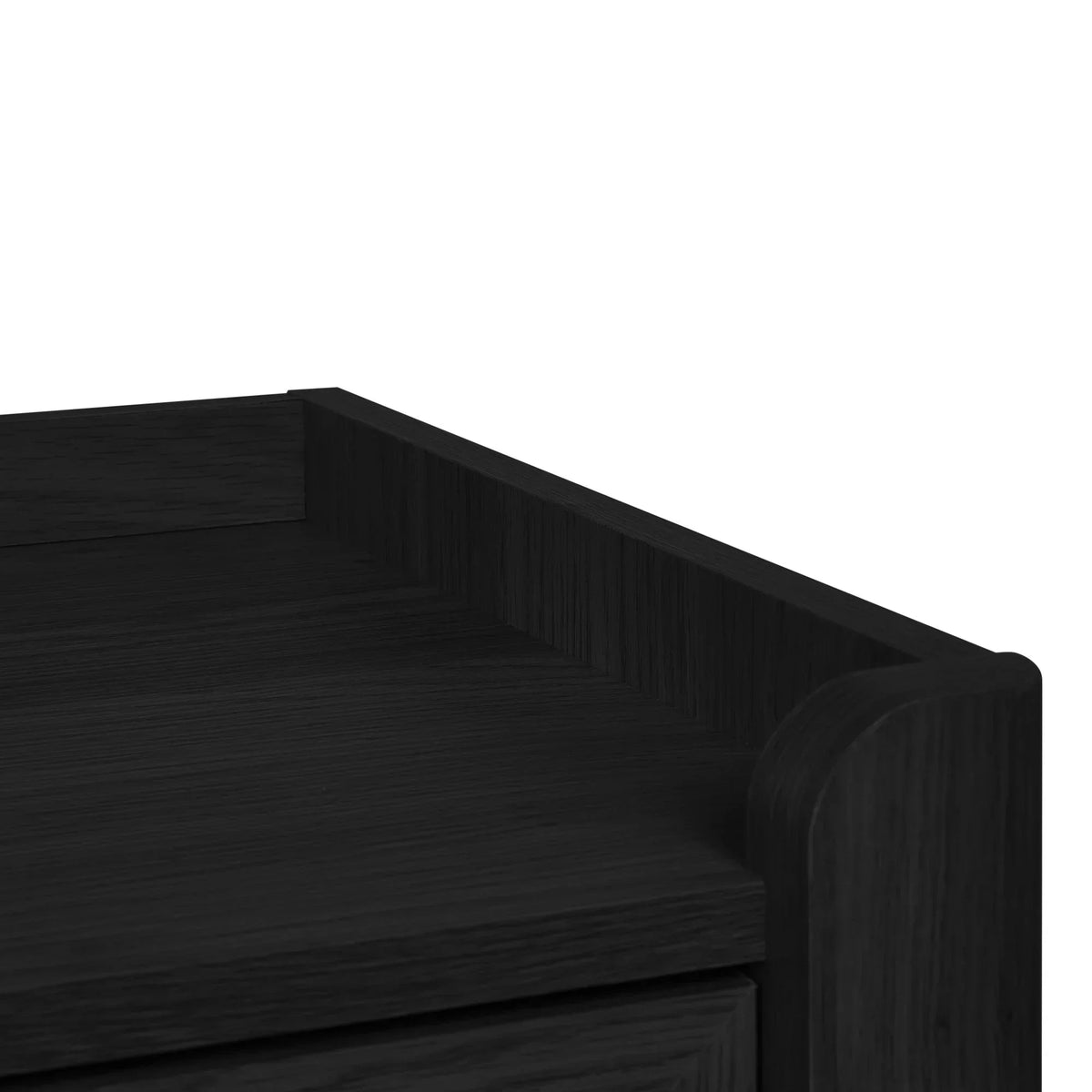 Corner detail of black ash rattan effect wide chest showing wood grain and drawer edge