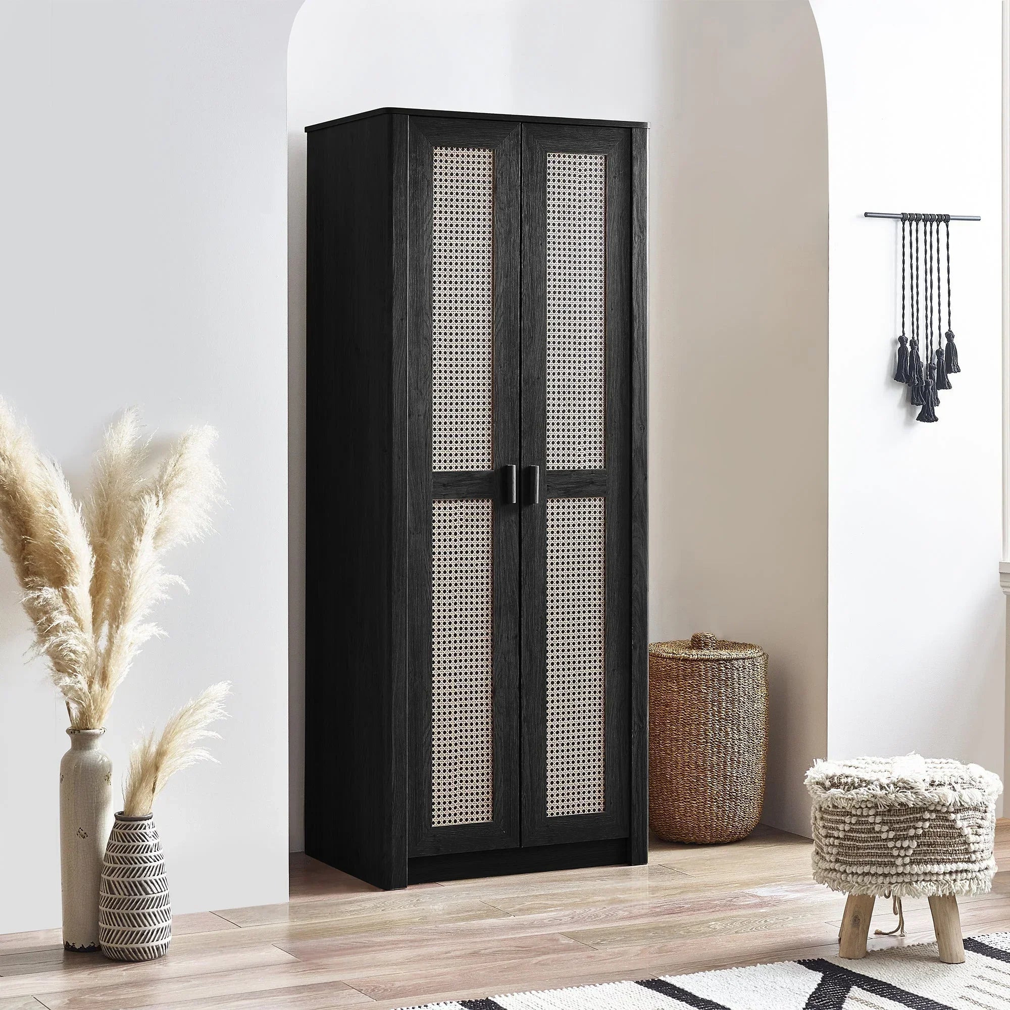 Black rattan effect wardrobe with two doors in modern bedroom setting, light wood floor