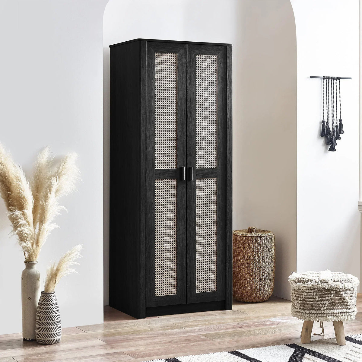 Black rattan effect wardrobe with two doors in modern bedroom setting, light wood floor