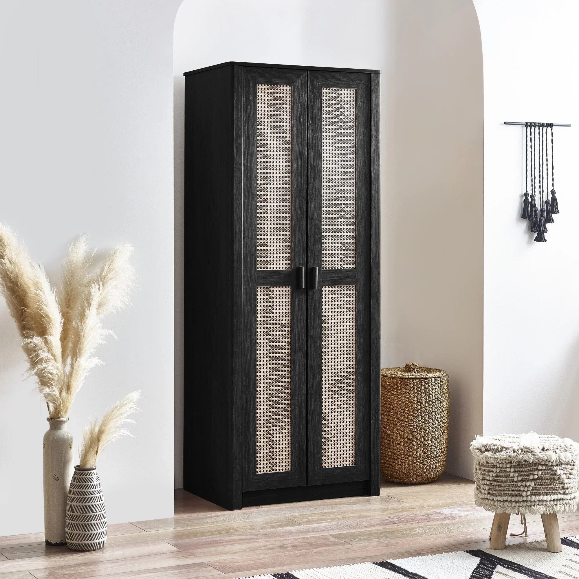 Black rattan effect 2 door wardrobe in modern room with woven basket and pampas grass