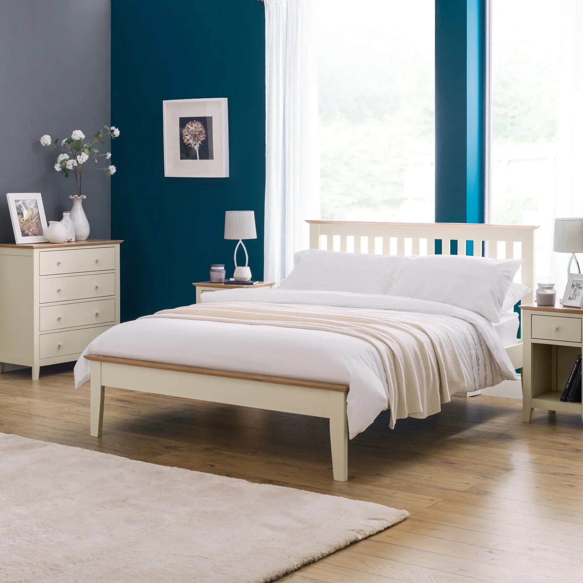 Two-tone wooden bed with matching bedside tables and chest of drawers in modern bedroom