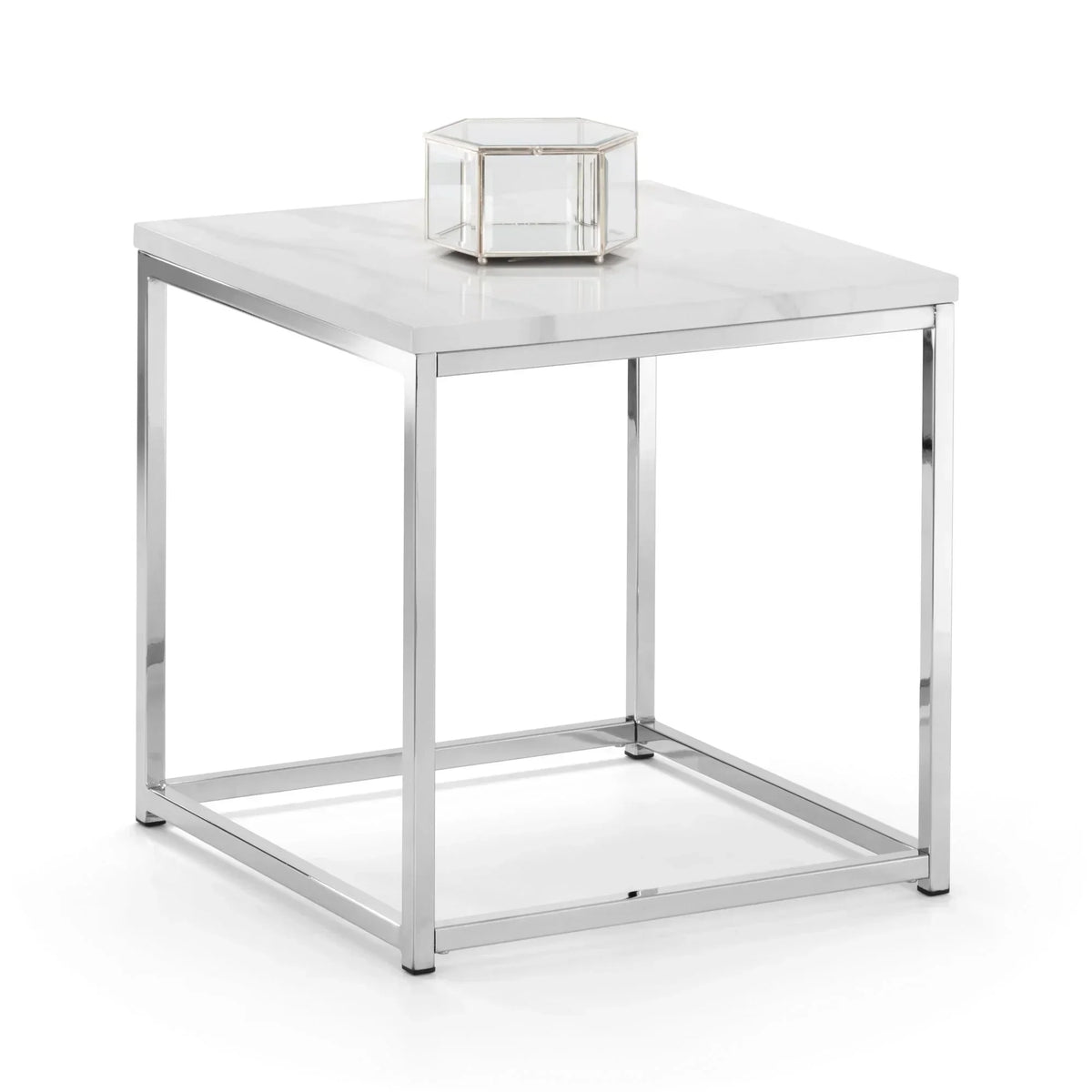 Modern square table with white marble top and chrome frame, glass candle holder on surface