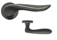 Matte black door handle with gold trim and round rose detail, shown from two angles
