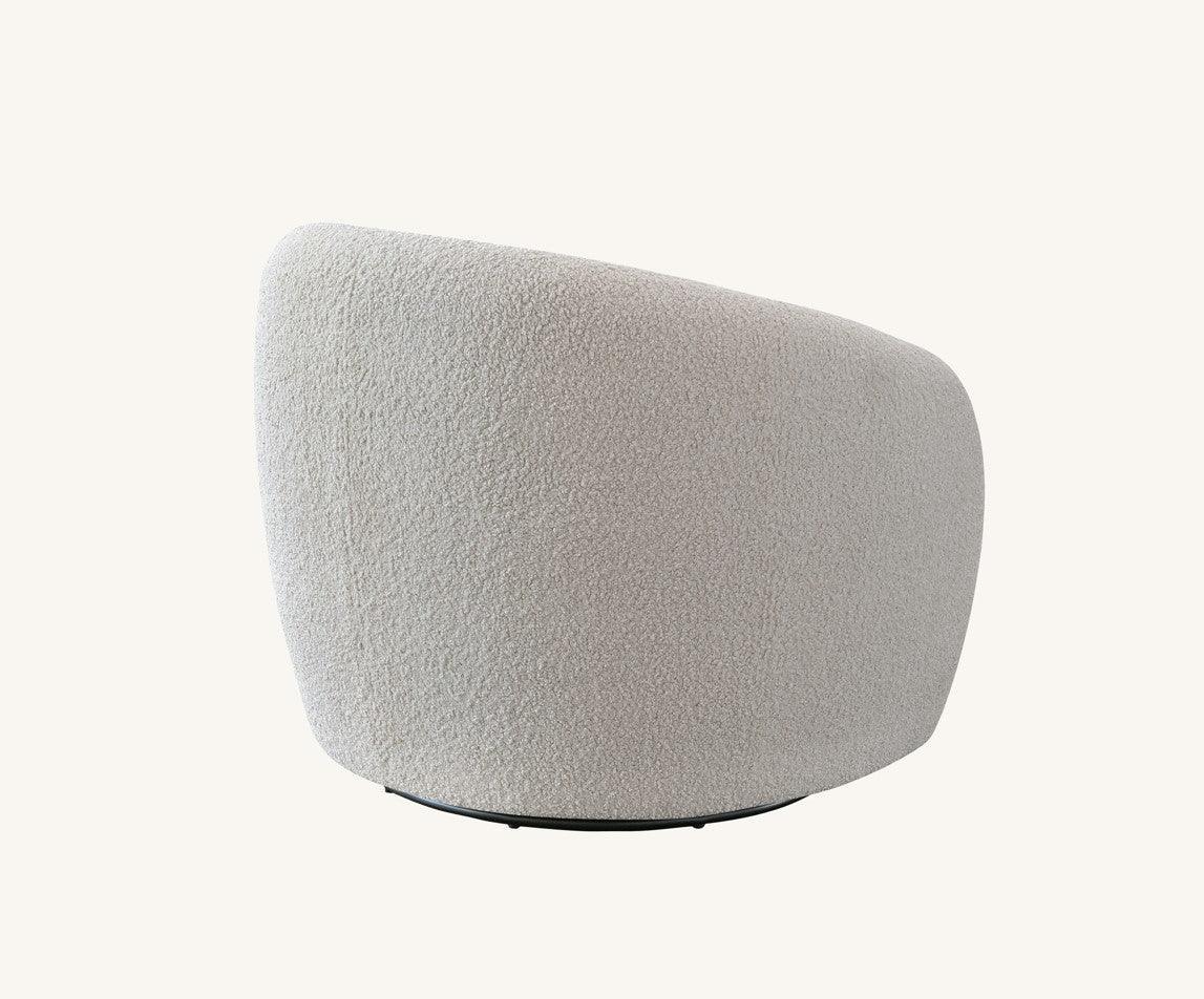 Curved boucle accent chair in soft beige fabric, rear angle view