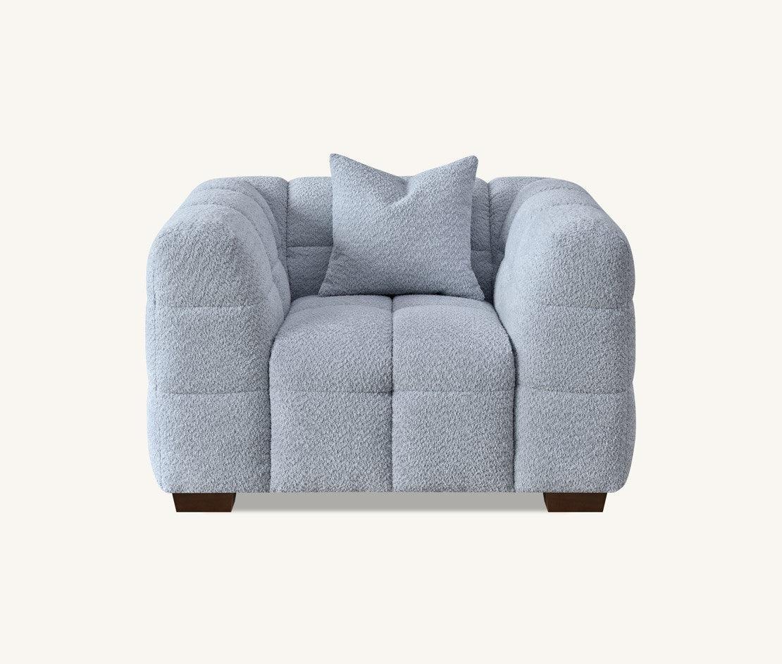 Light grey fabric armchair with plush cushioning and matching throw pillow, front view