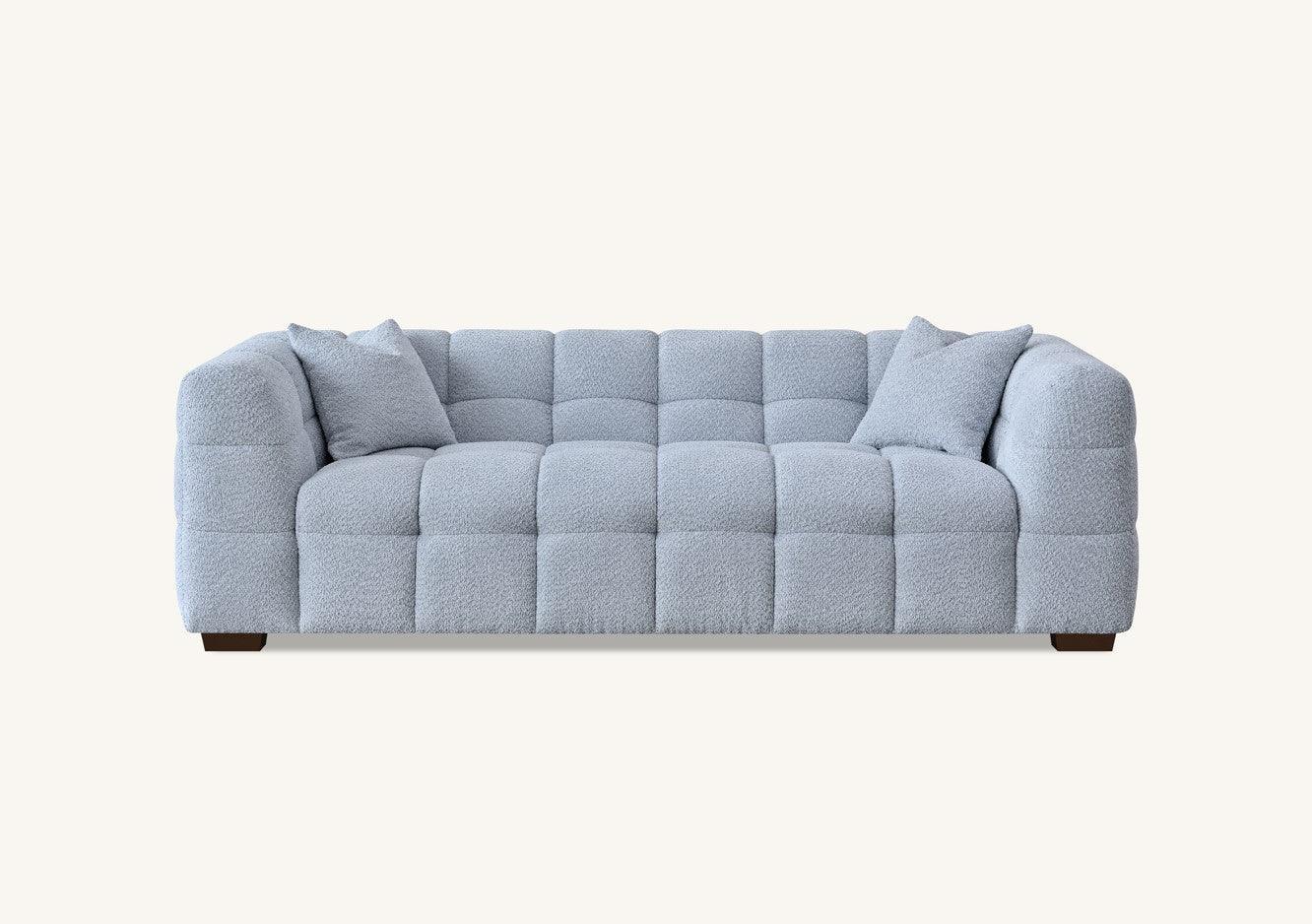 Light grey fabric sofa with quilted upholstery and two matching cushions, front view