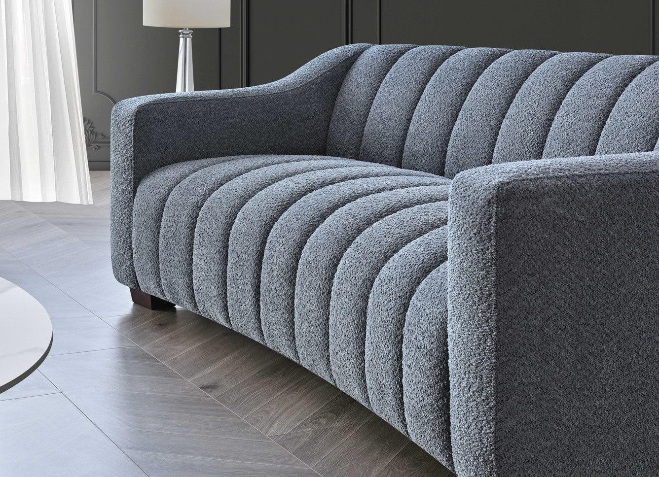 grey textured fabric sofa with vertical channel tufting in modern living room setting