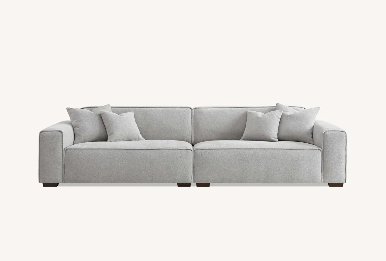 Light grey corner sofa with square arms and scatter cushions, front view
